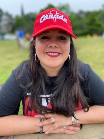 Woman smiling with Canada hot on.
