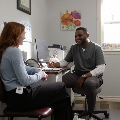 Doctor with patient in clinic office