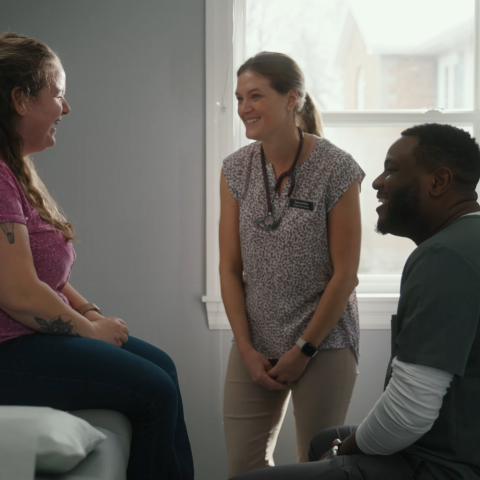 Doctor with nurse and patient in clinic office
