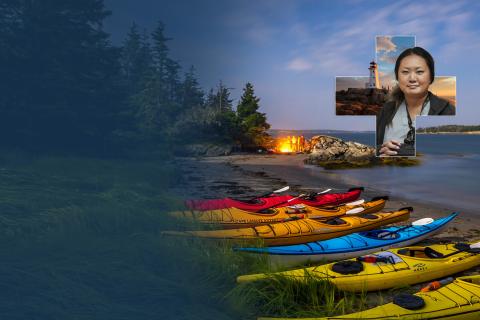 kayaks resting on a shore with a campfire in the background