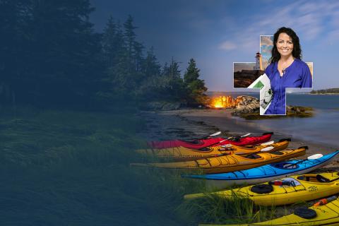 kayaks resting on a shore with a campfire in the background