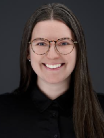 headshot of woman in dark blue shirt