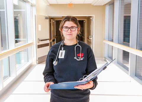 healthcare worker standing in a hallway