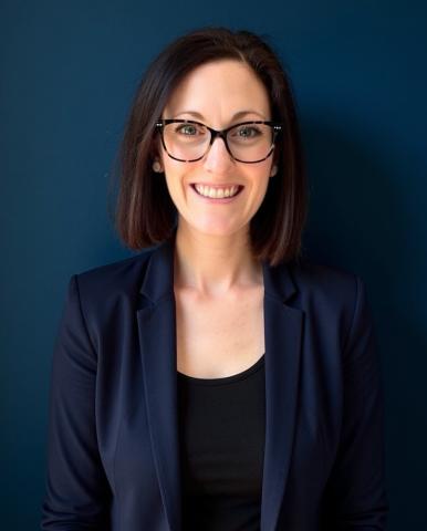headshot of a woman in a suit